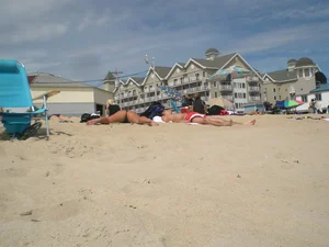 Milf laying out on a beach in Maine in her little thong