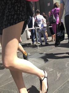 Long Skinny Legs in a Skirt and Feet in Sandals Closeup Creepshots on the Street