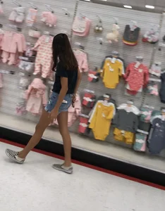 Skinny Girl With Thin Legs in Denim Shorts at the Store Candid Photo