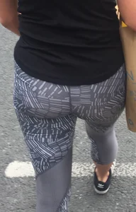 Sexy girl walking in grey patterned leggings with friend in tight jeans