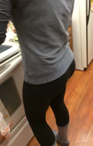 Sexy booty of a girl in leggings and socks at the kitchen
