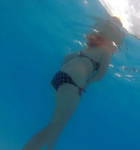 Underwater shots of a bikini teen swimming in the pool