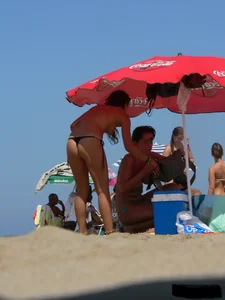 2 topless thonged sexy friends on the beach with great bodies