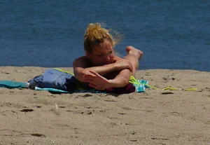 Sexy ass blonde milf on the beach in a thong with cameltoe and bending over