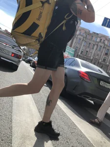 Amazing cute candid food delivery girl with lots of tattoos crossing the street
