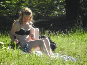 Two sexy friends in black bikinis laying out