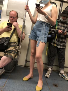 Girl in Blue Denim Shorts and Flats Standing in Subway Train - Nice Legs Closeup