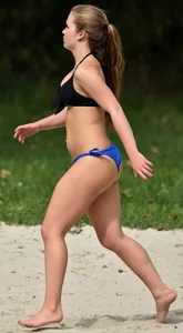 Cute girl playing volleyball in her little bikini