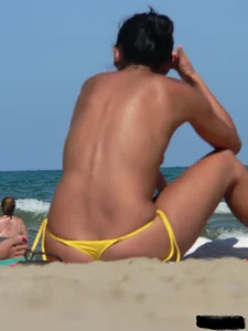 Bunch of sexy babes on the beach topless and in thong bikinis