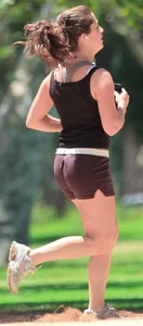 Cute girl running in short shorts
