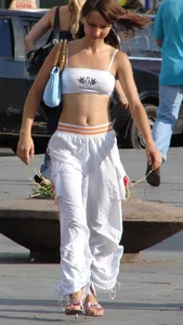 Cute flat-chested candid girl in a top with a wonderful tummy