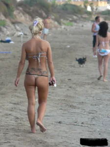 Tattooed blonde with big tits topless and in thong