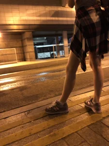 Cute Teen in Shorts on the Tram Stop