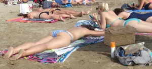 Hot Girl in a Blue Swimsuit Lying on the Beach