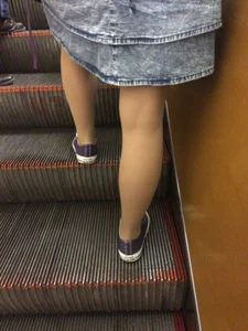 Girl in Denim Skirt with Skinny Legs on the Subway Escalator Candid