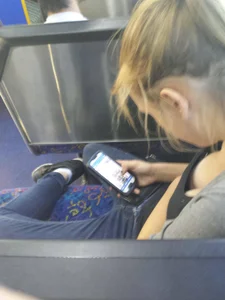 Skinny girl sitting in a public bus