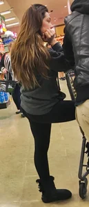Fit shopping brunette girl in leggings and a hoodie with a nice ass
