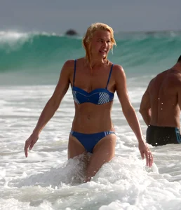 Blonde milf in a blue bikini looking sexy at the beach