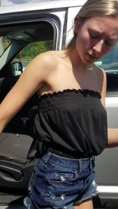 Pretty babe with small boobs in black top getting out of her car