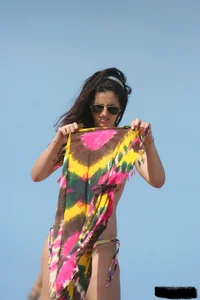 2 topless girls at the beach in thongs