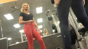 Very hot and sexy blonde at the gym working out in red leggings