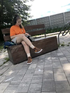 Cute candid teens reading on street benches