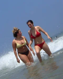 Thick girl and her skinny friend in bikinis at the beach