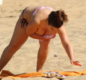 Thick girl on the beach with big boobs and a big booty