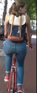 Blonde girl on a bike with a big tight ass in tight jeans