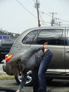 Girl cleaning her car in jeans and showing some cheetah print underwear