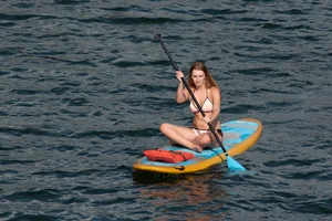 Tall, busty redhead in a skimpy bikini