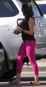 Milf brunette in purplish-pink leggings looking sexy in the parking lot