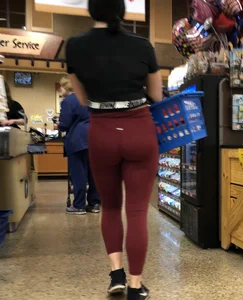 Girl with a nice ass in maroon leggings shopping