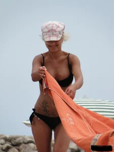 Tattooed blonde with big tits topless and in thong