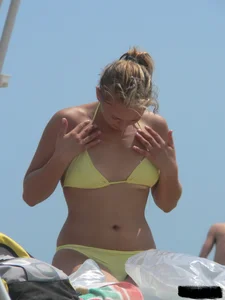 Sexy blonde on the beach in a yellow thong bikini