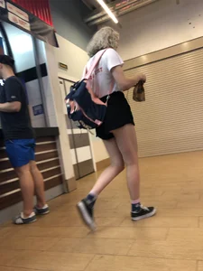 Teen with Fit Muscular Legs in Shorts Food Court Candid