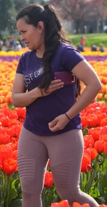 Cute babe in tight leggings taking pictures in flower fields