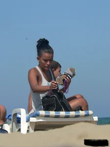 Hot ass topless beach girl with great tits lets her little brother oil up her ass in thong bikini