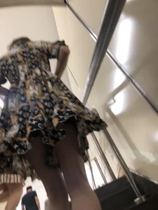 Low angle pics of a candid girl wearing a dress with long and very slim legs