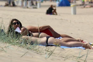 Thick and sexy friends out on the beach in shorts and bikinis