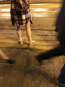 Cute Teen in Shorts on the Tram Stop