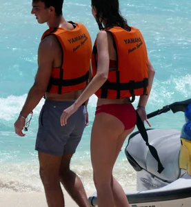 Tall sexy skinny brunette on the beach in a red bikini