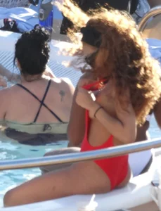 Sexy black girl in red swimsuit at the pool with side boob and a nice ass