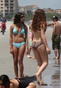 Brunette and redhead on the beach in bikinis looking sexy