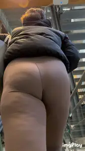 Tall curlyhead college girl in skin coloured leggings
