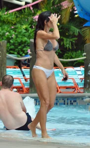 Sexy brunette lady with nice tits at the pool in a semi thong bikini