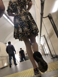 Low angle pics of a candid girl wearing a dress with long and very slim legs