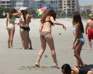 Brunette and redhead on the beach in bikinis looking sexy