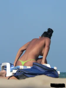 Hot ass topless beach girl with great tits lets her little brother oil up her ass in thong bikini