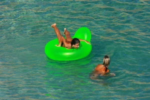 FKK Nudists playing in the water with floater